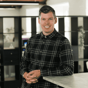 Man stood at a bar looking at the camera