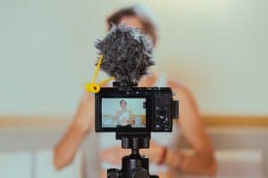 Shallow Focus Photo of a Video Camera Recording an Elderly Woman