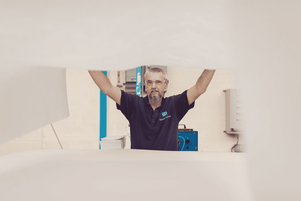 A Sealy team member testing a mattress spring unit
