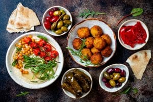 A table with vegan foods and bowls on it