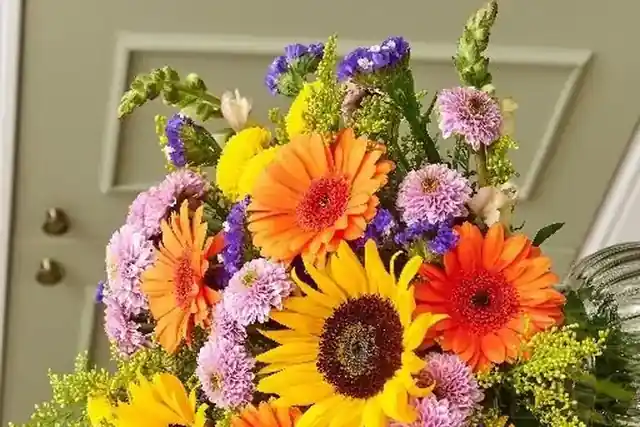 A bright Prestige Flowers bouquet with sunflowers and gerberas