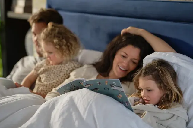 A family relaxing in a Sealy bed