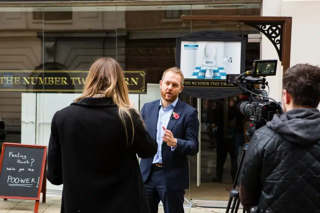 TV crew filming an interview outside the Number Two Tavern on launch day
