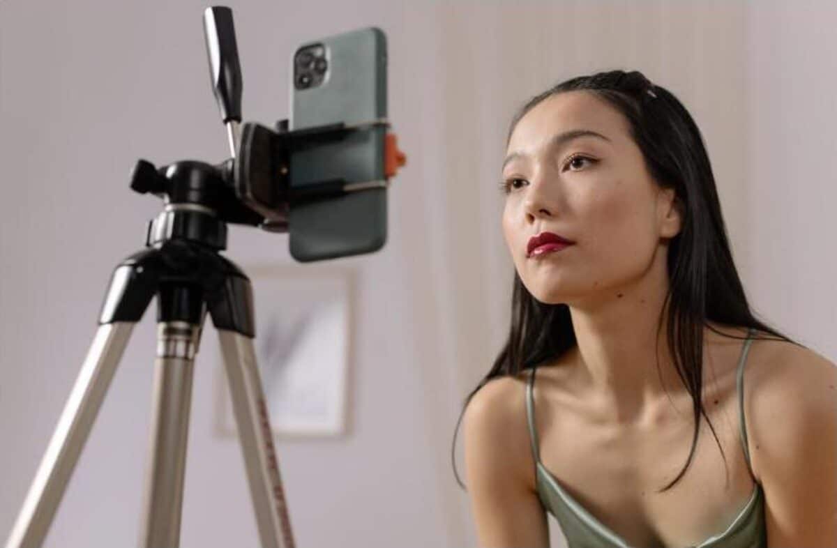 Influencer filming content on a phone tripod, representing Lydia Millen's editorial-style influencer marketing content