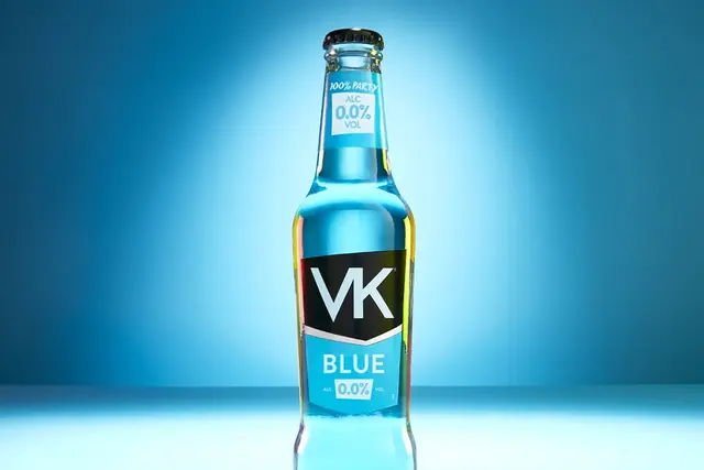 A bottle of VK Blue 0.0% against a blue background